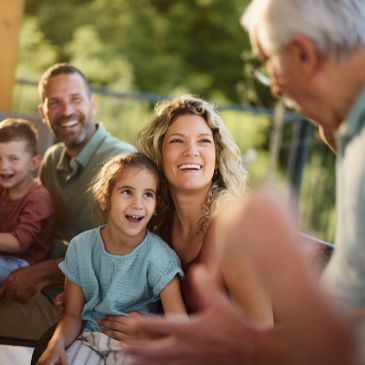 Family enjoying a joyful moment together outdoors.