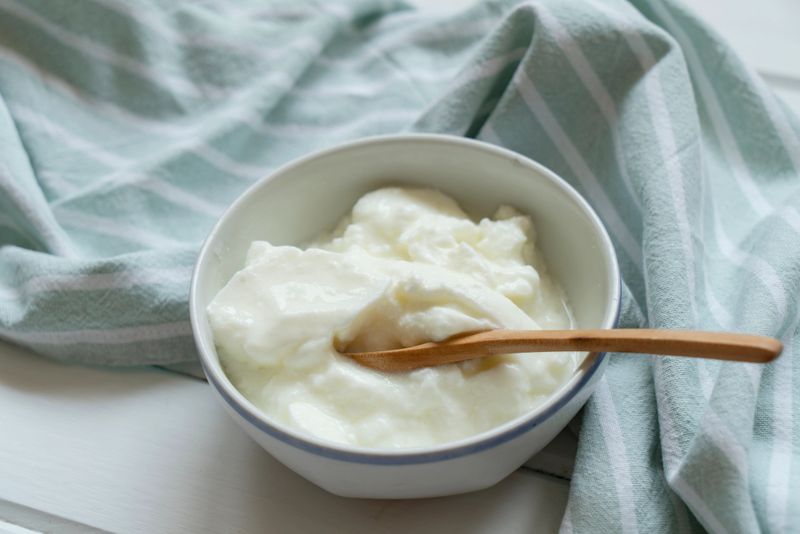 Homemade Yogurt in bowl on white wooden table