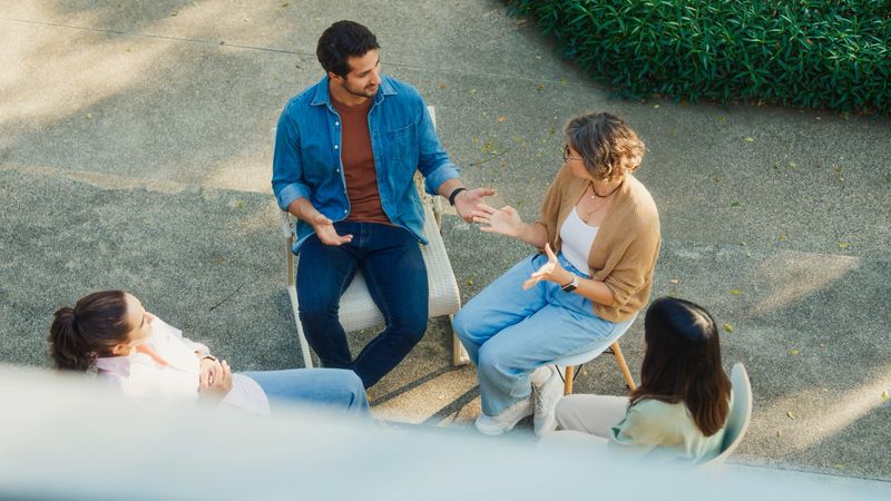 Top view diverse group people participating in outdoor community therapy session focused mental health awareness and support sharing advice to promote empathy togetherness. Mental health concept.