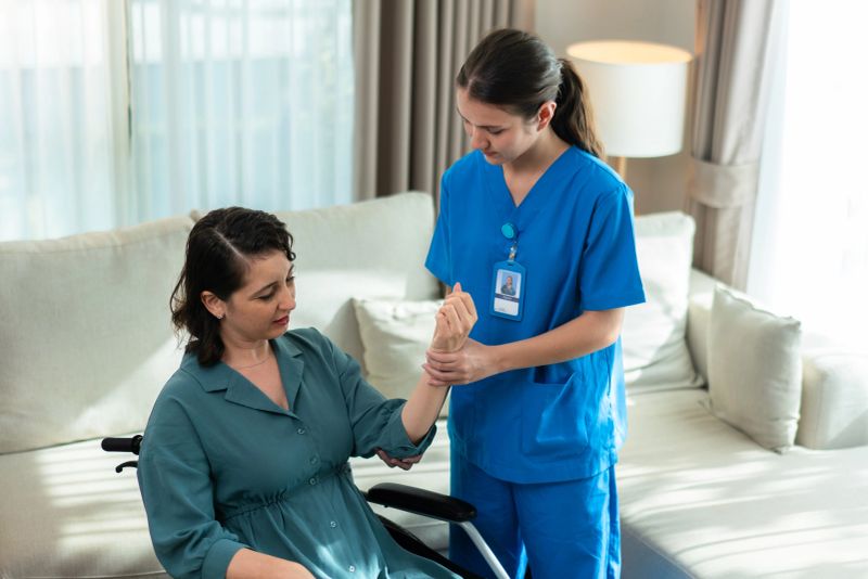 Female nurse explains and hands medication to senior woman during friendly and attentive home visit.