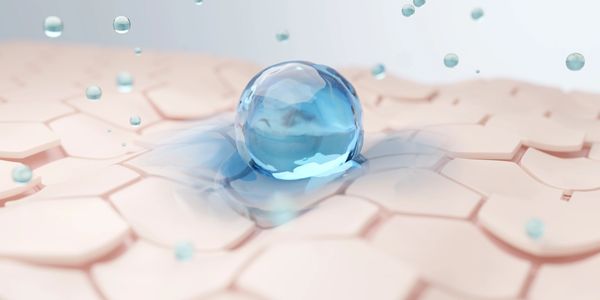 A blue water droplet on a hexagonal surface.