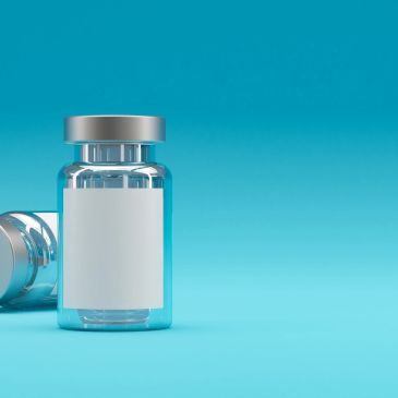 Two medical vials with blank labels on a blue background.