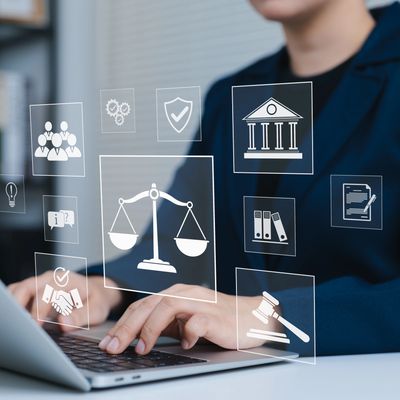 Person typing on laptop with legal icons overlayed.