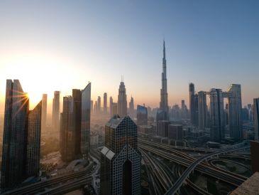 Sunrise over Dubai's skyline with Burj Khalifa.