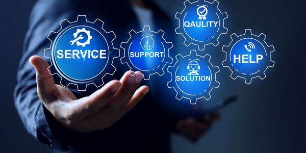 Hand presenting floating gears with service-related icons and keywords.