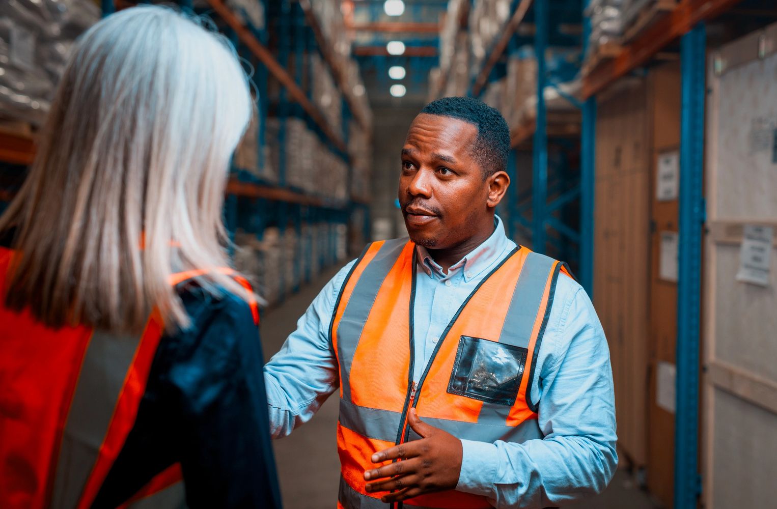 Stack of books next to pencils in a holder and a camera.