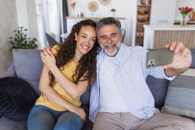 Father and daughter are taking a selfie together, enjoying a heartwarming moment of connection and creating lasting memories