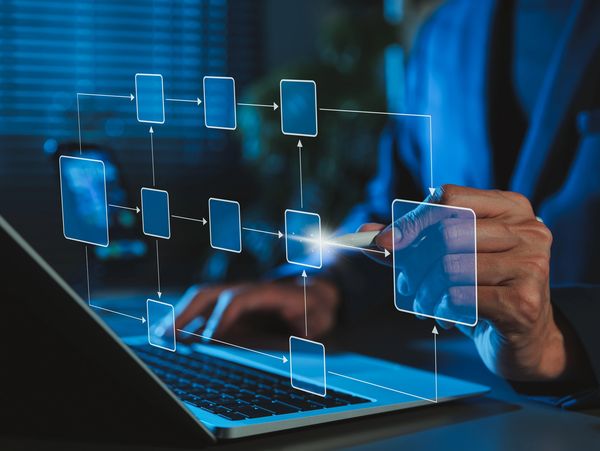 Person interacting with a digital flowchart on a laptop screen.