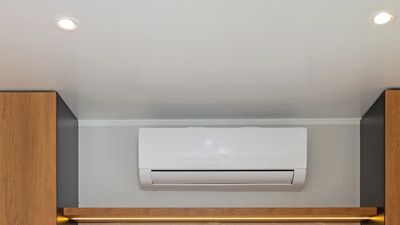 Wall-mounted air conditioner in a room.