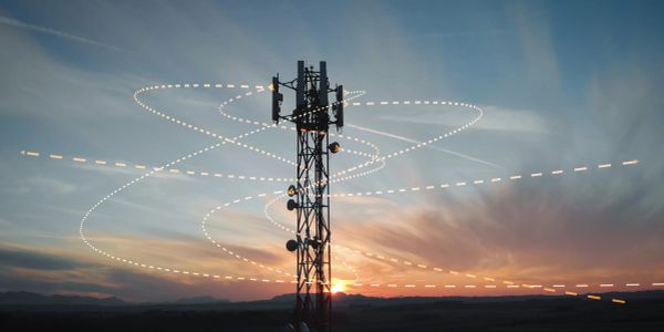 Communication tower with digital signal effects at sunset.