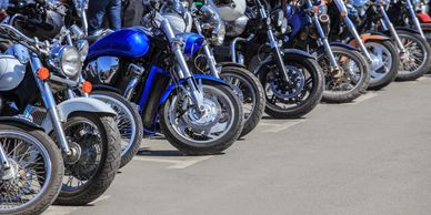 Row of parked motorcycles on a street.