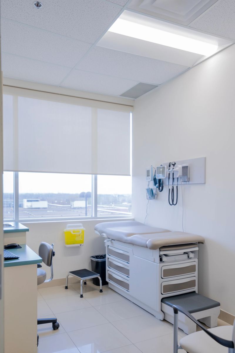 Bright and clean medical examination room displaying essential healthcare furniture and tools, creating a professional and welcoming atmosphere for patients and practitioners in a contemporary healthcare facility.