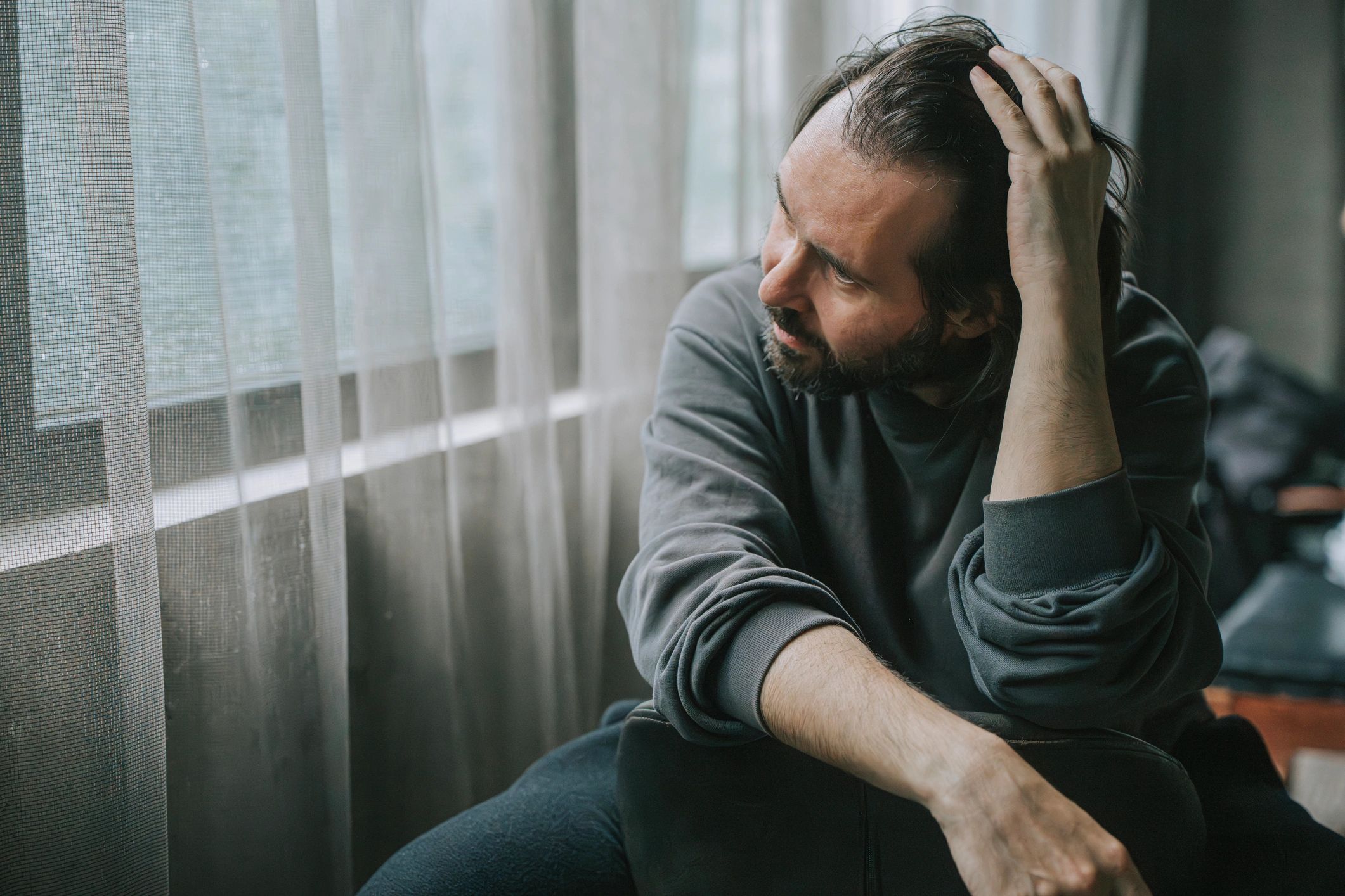 Man looking out window