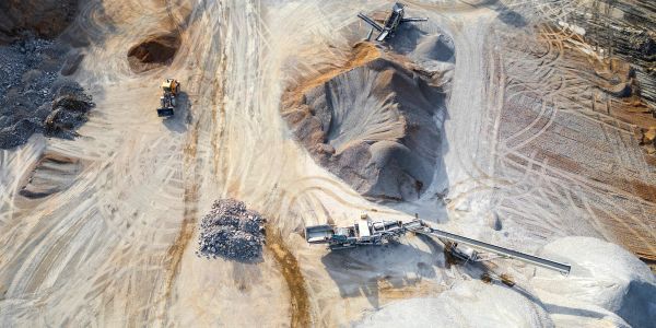 Quarry site with heavy machinery and equipment.
