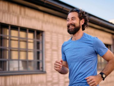 Man jogging outside in blue shirt.