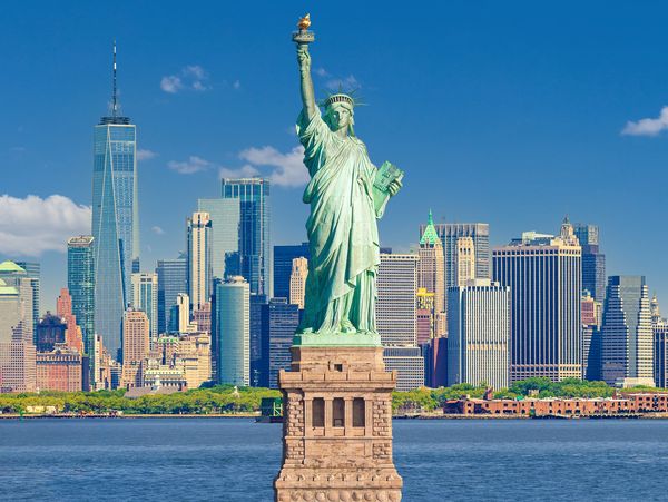 Statue of Liberty with Manhattan skyline behind.