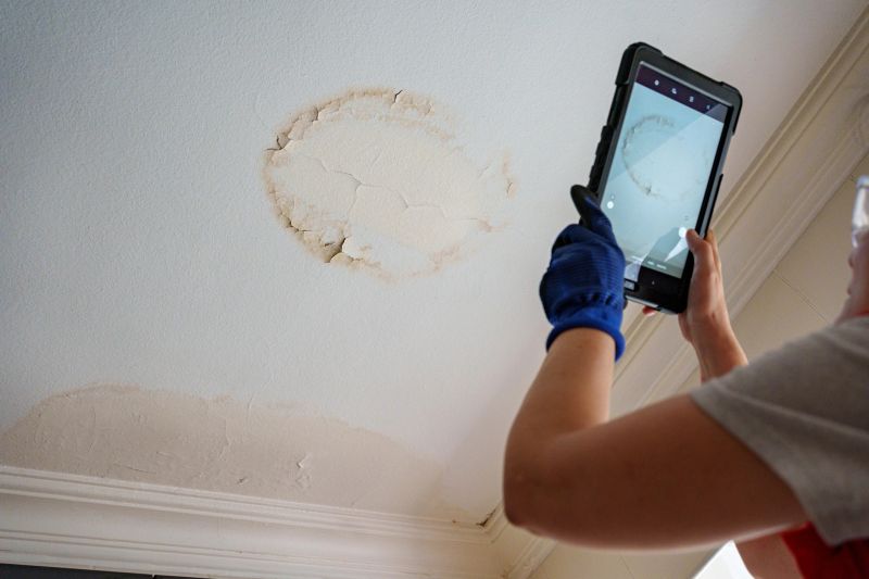 Worker fix leaking pipe in ceiling ,close-up of a stain on the ceiling, Insurance Adjuster Inspecting Damages On Construction Site