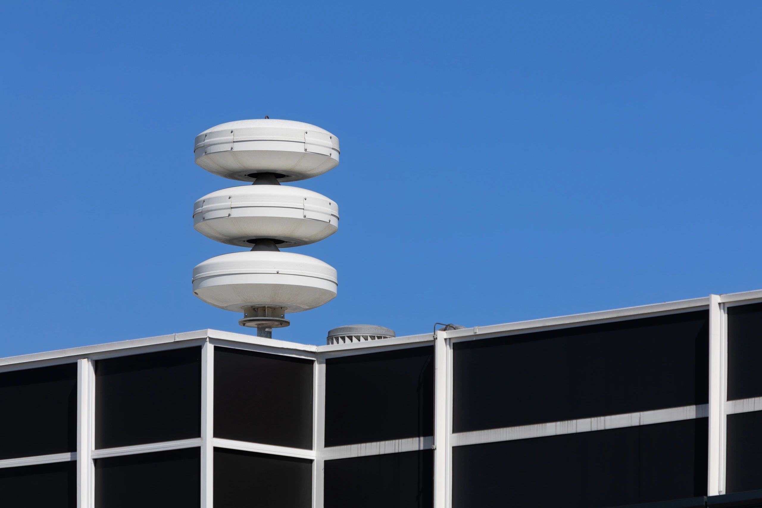 Outdoor warning siren installed on the rooftop of a commercial facility