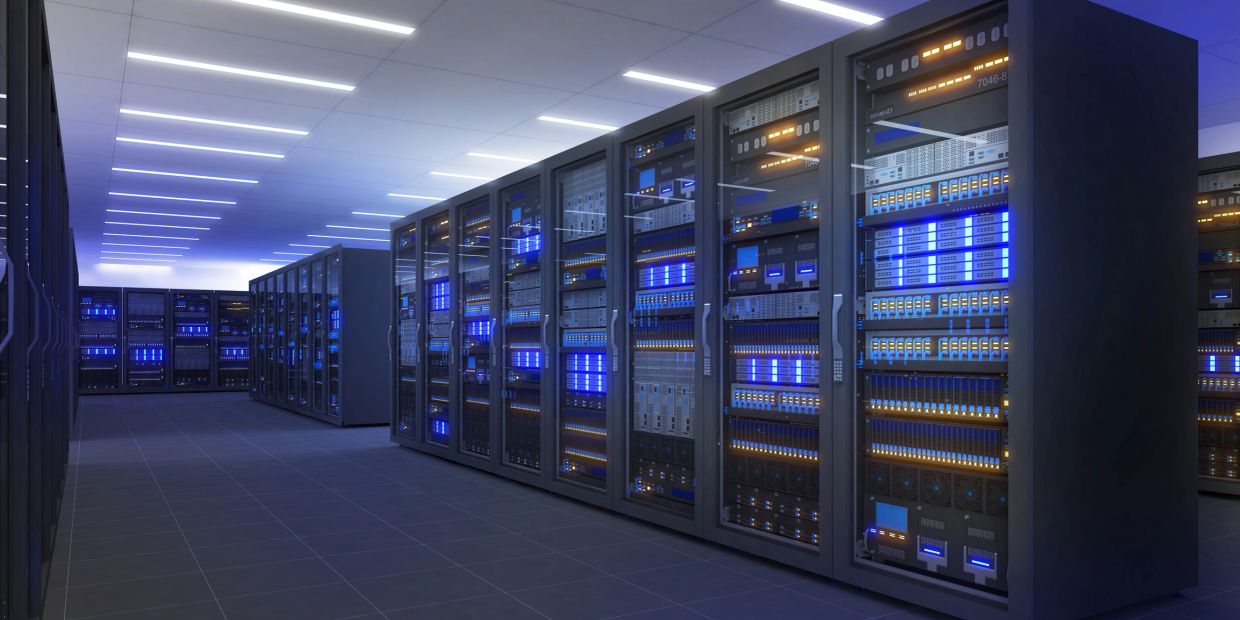 Rows of illuminated server racks in a modern data center.