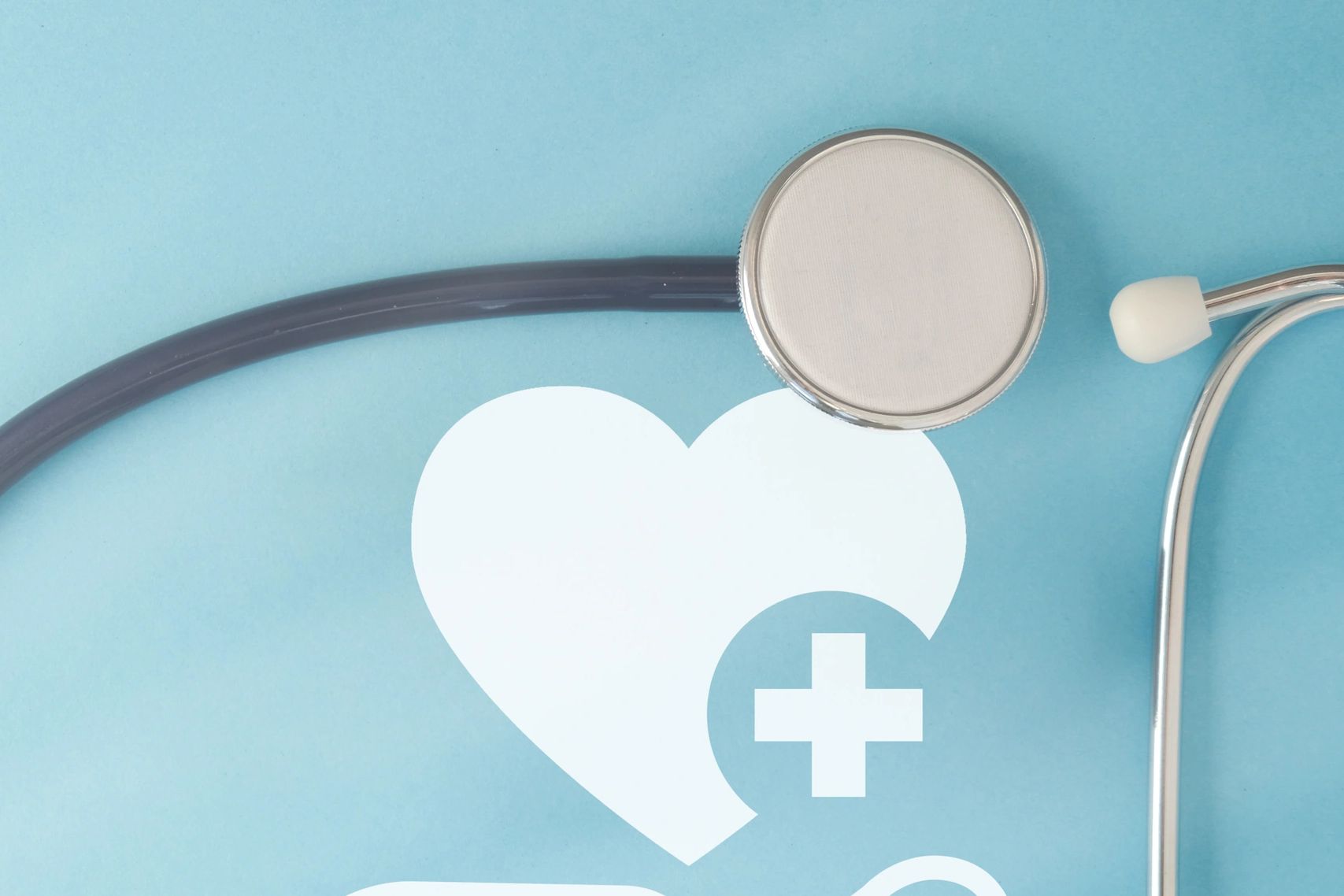 Stethoscope with a healthcare symbol on a blue background.