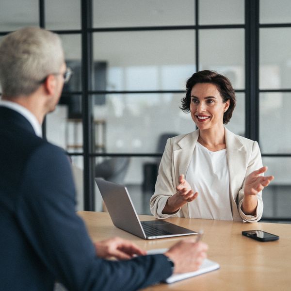 Two Business Professionals talking about how to help their clients get the best services 