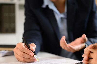 Customer signing a document, representing agreement to Intersolar window tint's terms of service