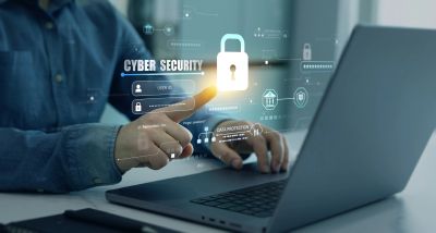 Person interacting with cybersecurity interface on laptop.