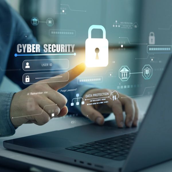 Person interacting with virtual cybersecurity interface over laptop.