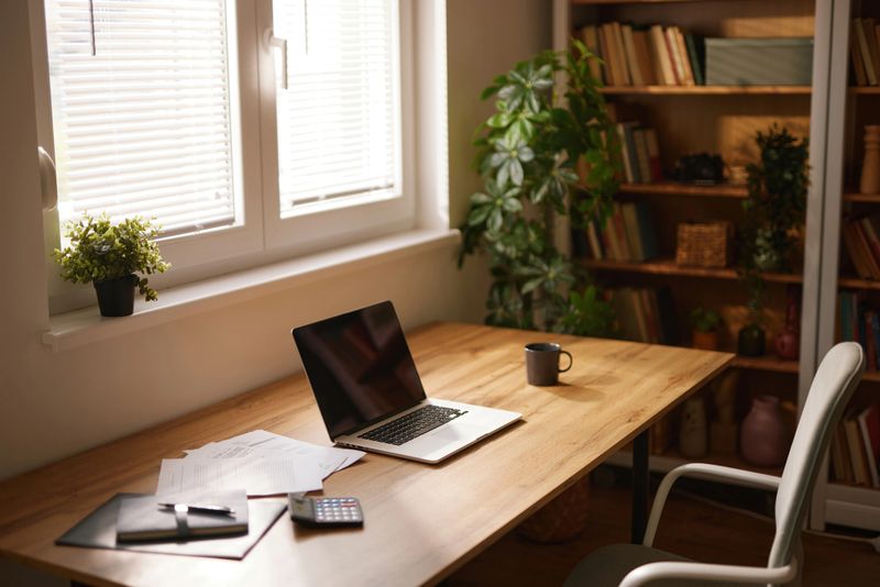 Cozy home office with laptop, documents, and a cup of coffee, ready for a productive workday