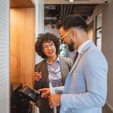 Two colleagues engaged in a friendly office conversation.