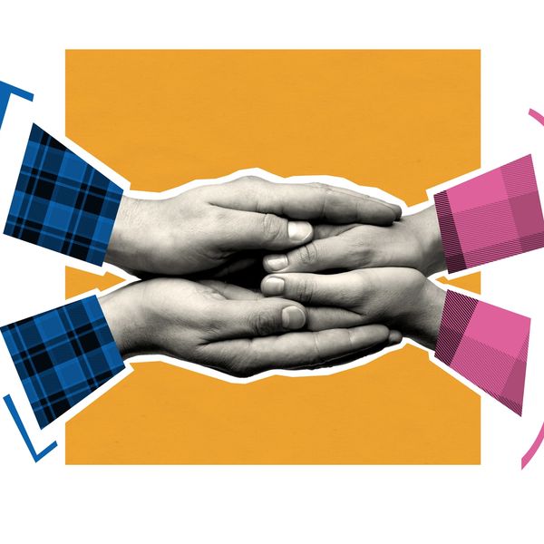Two pairs of hands gently holding each other with colorful sleeves.