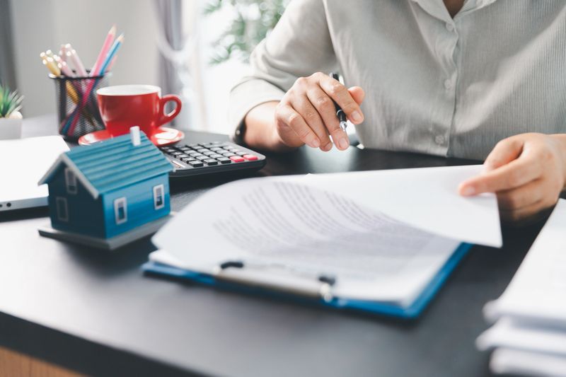 Real estate agent agree to buy home to clients agency office. House model, real estate agent, customer discussing for contract to buy house, insurance, loan real estate background. Concept agreement.