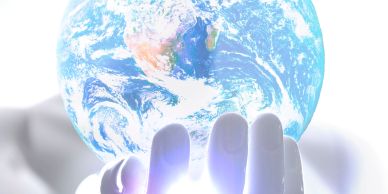 A hand gently holding a glowing Earth, symbolizing care for the planet.