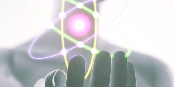 Futuristic figure holding a glowing atom model in hand.