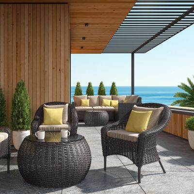 Cozy wicker patio furniture set on a terrace with ocean view.