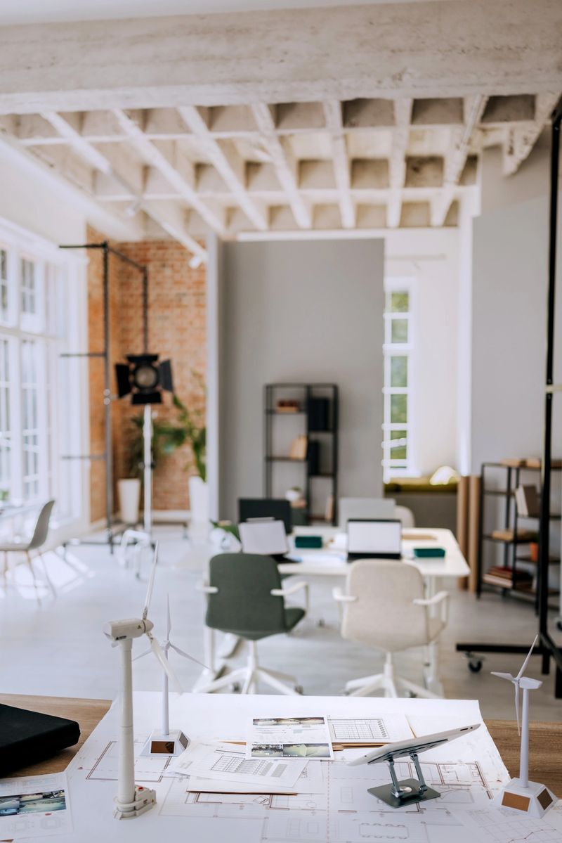 Minimalist office space featuring a table with small wind turbine models. Quiet and clean environment ready for innovative teamwork and creative projects.