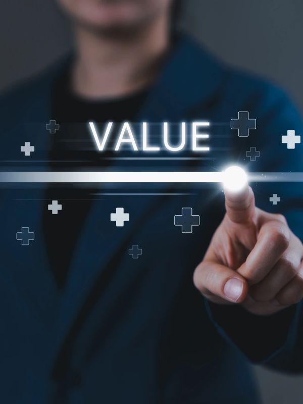 Person in suit pointing at glowing word 'VALUE' with digital plus signs.