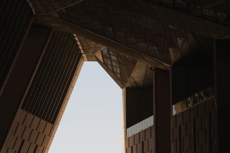 Low angle view of modern architecture featuring geometric shapes and abstract design, creating a visually striking composition