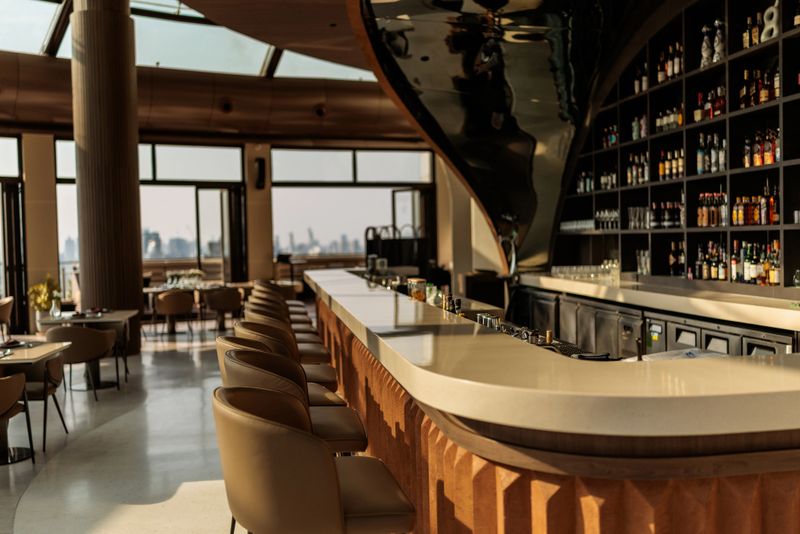 Elevated high above the city, this elegant rooftop bar offers a calm, sophisticated vibe — ideal for slow moments and skyline views. Bangkok, Thailand.