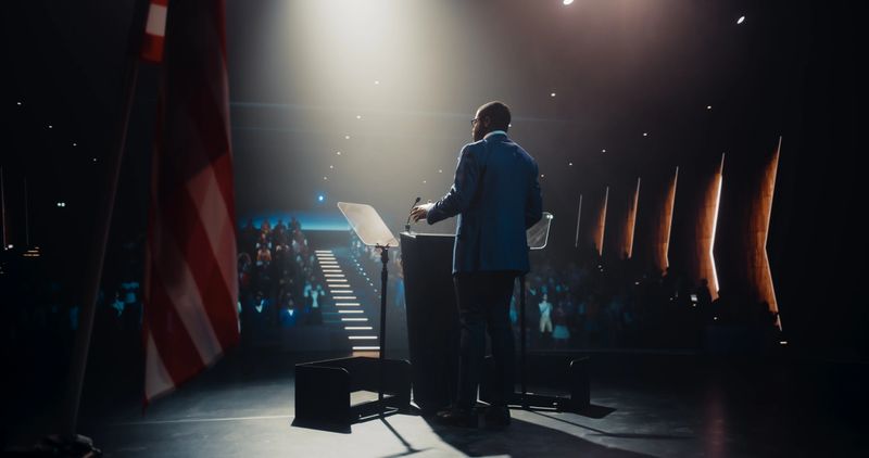 Politician Delivering a Speech at a Campaign Rally. Political Party Member Giving a Passionate Presentation to Excited Voters, Promising Wealth and Prosperity to United States of America