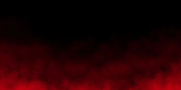 Red smoke or fog rising against a dark background.