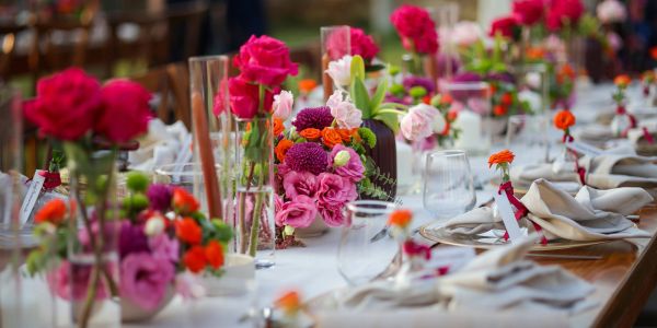 Elegant table setting with colorful floral arrangements.