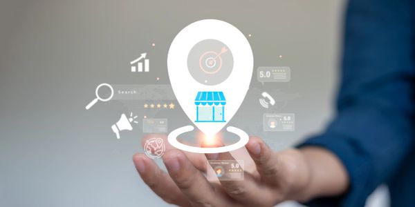 Person holding a light bulb with business icons.