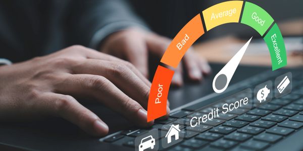 Hand typing on keyboard with a credit score gauge showing 'Good' rating.