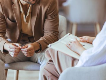 A man and a therapist in a counseling session.