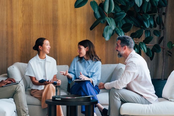 A diverse group having a relaxed meeting in a modern lounge.