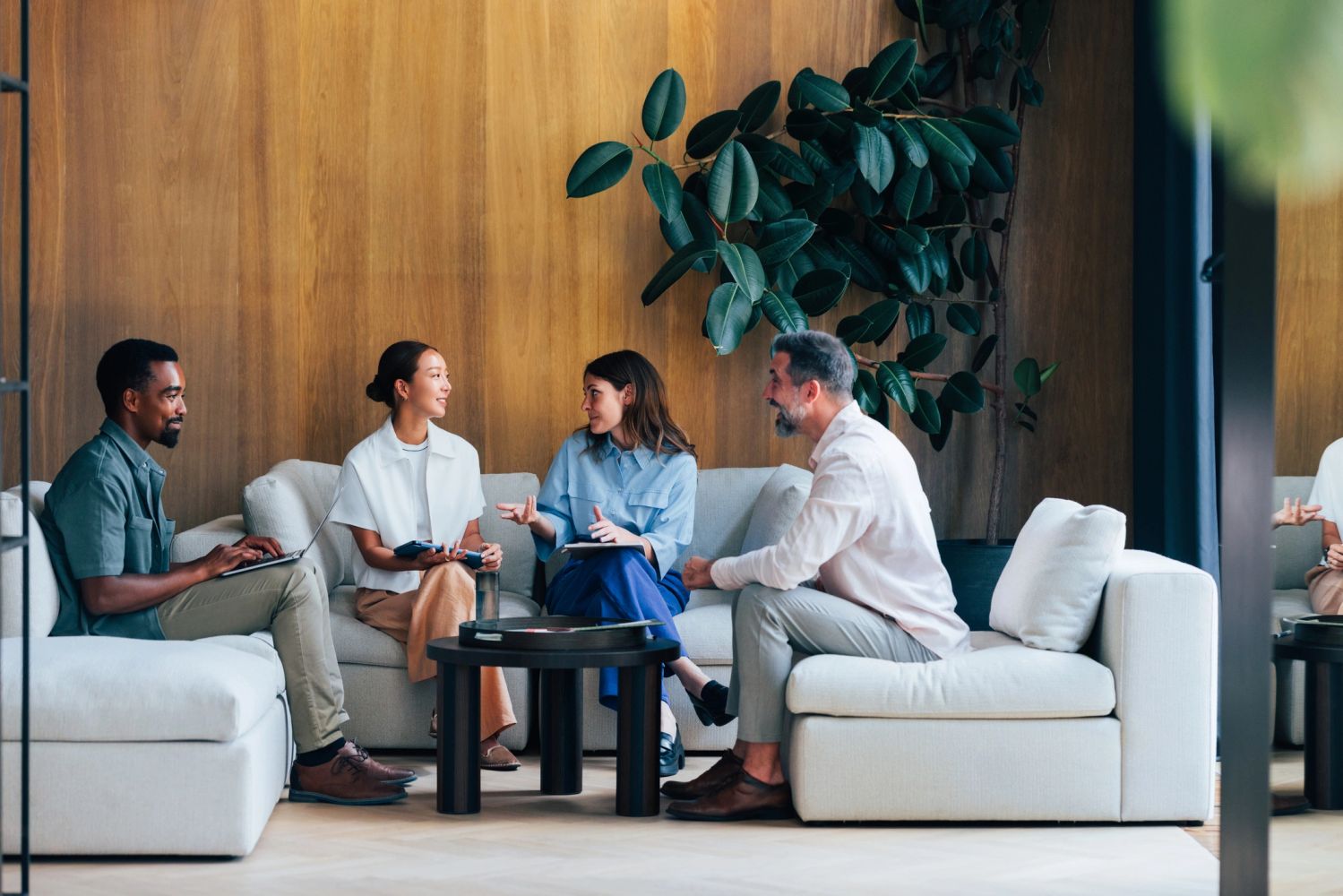 Three business professionals having a meeting in a bright office.