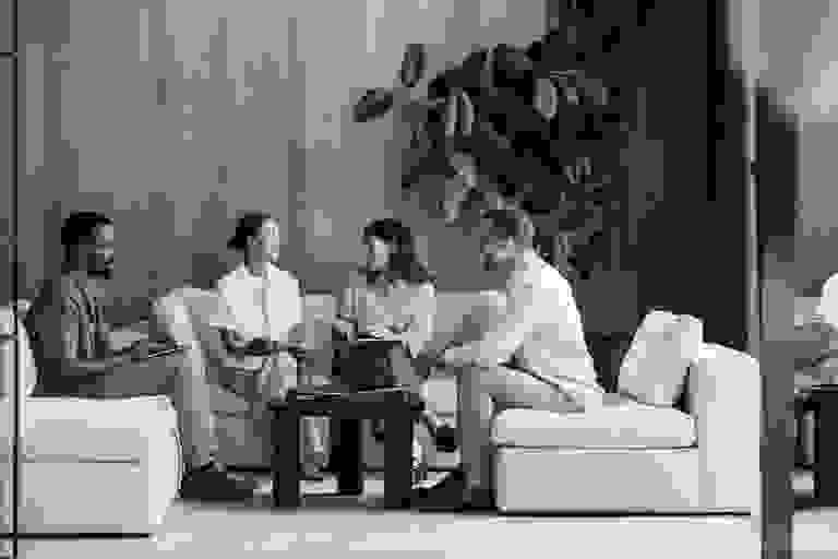 Stack of books next to pencils in a holder and a camera.