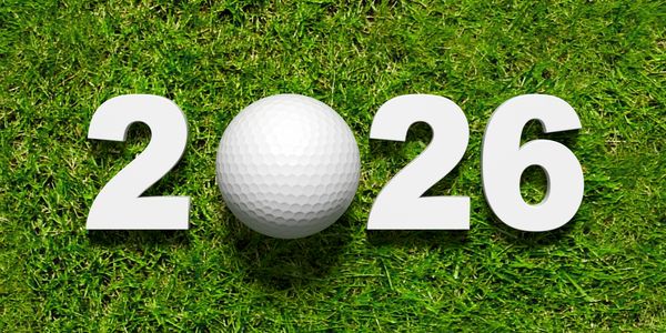 Golf ball replaces zero in 2026 on green grass.