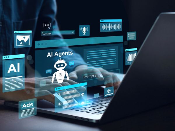 Person working on a laptop with AI-related digital icons surrounding it.